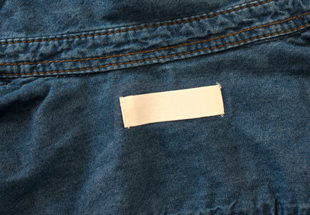empty white label on blue denim textile