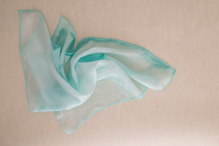 turquoise silk - close up of a hand painted silk scarf - pastel tone on white transparent silk