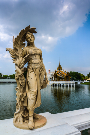 Angel statue with Thai traditional pavillion in the pond of Bangpa-in palace, Ayuthaya, Thailandの写真素材