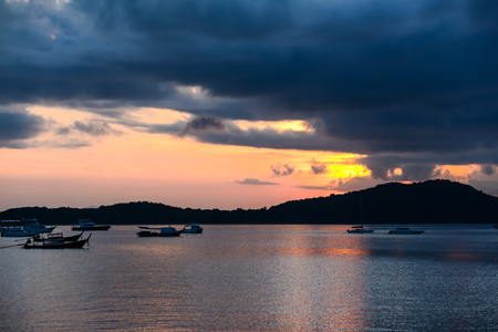 Fishing boats and tourism  boats on sea in the morning of rainy day.の写真素材