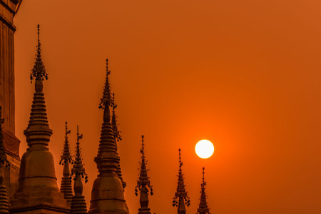 Group of pagodas during sunrise in Buddhist temple of Thailandの写真素材