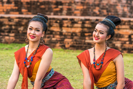 KALASIN, THAILAND - FEBRUARY 20, 2016: Girl   dancers with local dress doing Thai Northeastern traditional dance at Yaku Pagoda to celebrate Buddism event in Kalasinのeditorial素材
