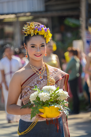 CHIANGMAI, THAILAND - JANUARY 25, 2015: Indigenous girl  with local traditional costume with a bowl of white flowers in parade of 22nd Traditional Skirt Fabric and The Indigenous Product and Culture Festival in Mae Chaem, Chiangmai, Thailandのeditorial素材