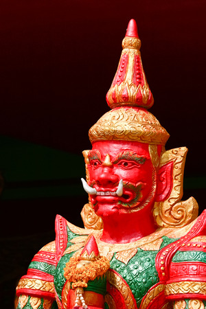 Thai literature giant with red face decotaed in Buddhist templeの写真素材
