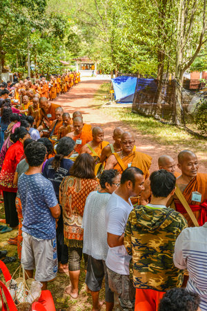 KRABI, THAILAND - MAY 3, 2015: Thai Buddhists offering food to monks' alms-bowl in Lanta island of Krabi, Thailandのeditorial素材