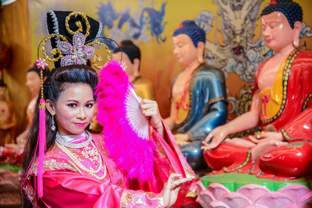 Chachoengsao, Thailand - July 14, 2013 : Beautiful woman with traditional chinese pink dress in Chinese shrine in Thailand.のeditorial素材