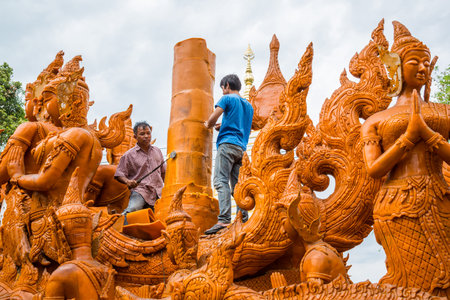 Ubonratchathani, Thailand-April 30, 2016: Artist men carving candle for marching in candle festival in Ubonratchathani, Thailandのeditorial素材