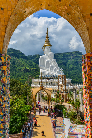 Phetchabun, Thailand - June 28, 2015: Buddhist tourists sightseeing beautiful white five Buddha Images at Phasornkaew Buddhist temple in Phetchabun, Thailandのeditorial素材
