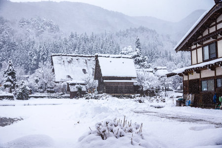Shirakawago, world heritage village, the tourist destination, in winter with snow falling in Gifu, Japanの写真素材