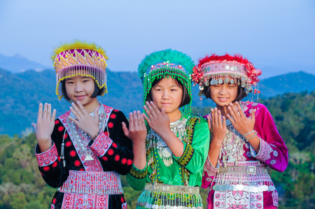 Tak, Thailand - November 11, 2011: Group of beautiful hill tribe girls with their colorful dresses playing traditional game in national public park of Thailandのeditorial素材