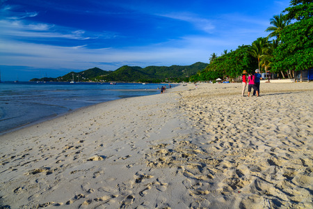 Surat Thani, Thailand - May 25, 2013: Tourists walking on beautiful beach in clear blue sky day in Surat Thani, Thailandのeditorial素材