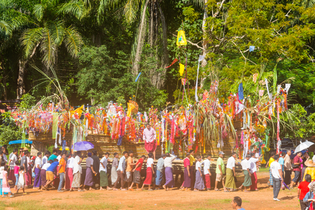 Kanchanaburi, Thailand - September 17, 2016: Buddhist Mon people celebrate the month of merit festival by marching to carry boat of worship food and things to river in Sangkhlabri, Kanchanaburi, Thailandのeditorial素材