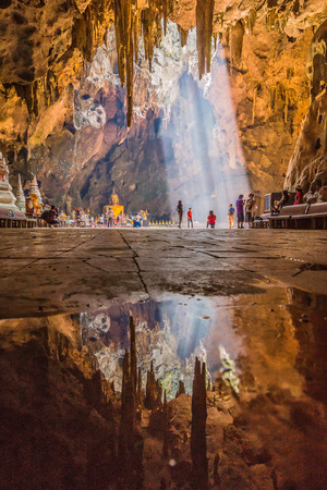 Phetchaburi, Thailand - May 15, 2016: Photographer shooting photography of beautiful golden Buddha image with many tourists in Khao Luang cave in Phetchaburi, Thailandのeditorial素材