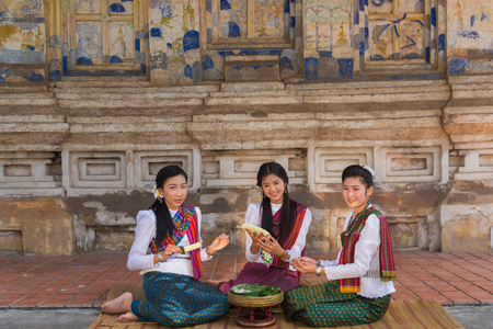 Khonkaen, Thailand - December 19, 2015: Group of beautiful girls making garlands together in ancient Buddhist temple in Khonkaen, Thailandのeditorial素材