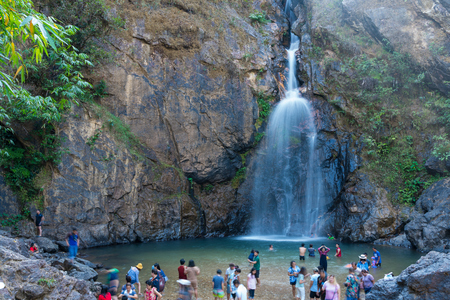 Kanchanaburi, Thailand - February 17, 2018: Tourists visiting and playing water at Chokkradin Waterfalls in national public park in Kanchanaburi, Thailandのeditorial素材