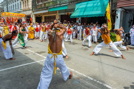 Phang Nga, Thailand - October 14, 2018: Men demonstrating using axe to hit the back in vegetarian festival parade in Phang Nga, Thailandのeditorial素材
