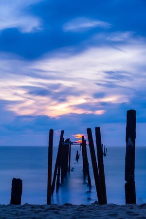 Broken wooden fisfing bridge during sunset at Khao PIlai in Phang Nga, southern of Thailandの写真素材