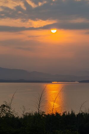 Beautiful sunrise  over the reservoir in national park in Thailandの写真素材