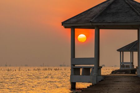 Beautiful view of sunrise at fisherman village in the morning at seaside.の写真素材