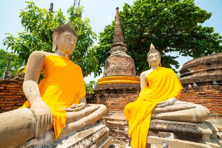 Ancient Buddha Images with pagoda in Wat Yai Chaimongkon, the buddhist temple in Ayutthaya, Thailandの写真素材
