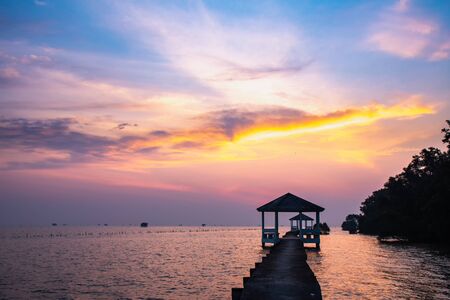 Beautiful view of sunrise at fisherman village in the morning at seaside. with wooden pavilionの写真素材