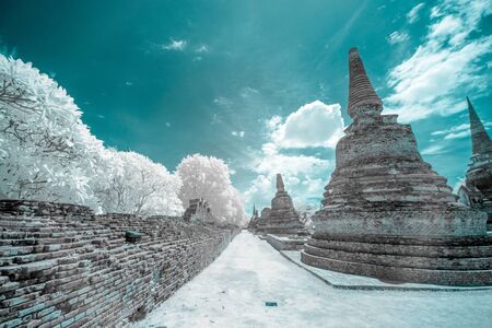 Ruined ancient Buddhist temple and pagoda in Ayutthaya historical park, Thailand in infrared photographyの写真素材