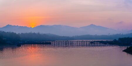 Panarama beautiful view of Mon wooden bridge in fog environment in early morning during sunrise in Sangklaburi, Kanchanabuei, Thailandの写真素材