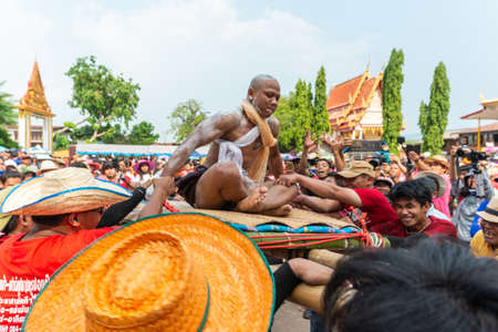 Chaiyaphum, Thailand - May 12, 2019: Parade of ancient pre-ordination of Buddhist which pre-monk on bamboo litter shaken severely before ordination in Buddhsit temple in Chaiyaphum, Thailandのeditorial素材