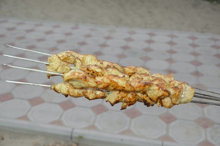 fresh roast chicken shish kebab on skewers at outdoorsの写真素材