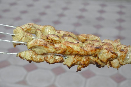 fresh roast chicken shish kebab on skewers at outdoorsの写真素材