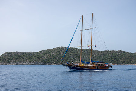 Kalekoy Simena , Turkey - June 03, 2019: Pleasure tourist yacht sailing near the island of Kekova in Turkeyのeditorial素材