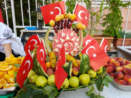 Fresh summer fruits in a watermelon basket decorated with Turkish flags. Composition with assorted fruitsの写真素材