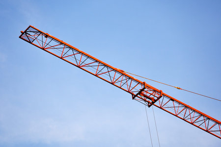 A huge crane's arm under the blue skyの写真素材