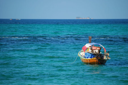 Long tail boat docking in the seaの写真素材