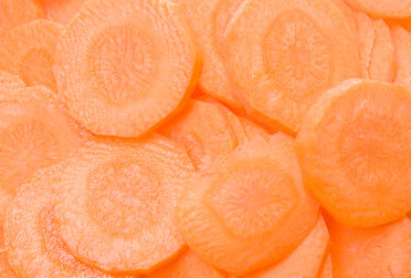 background of circular juicy carrot slicesの写真素材