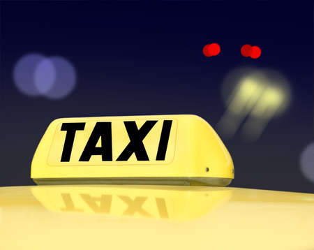 Taxi sign at night trafficの写真素材
