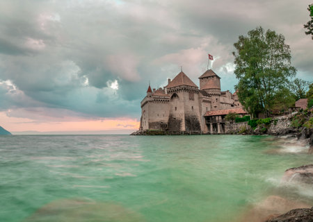 The beautiful old castle on Lake Geneva in Switzerland in the evening light with stormy waterのeditorial素材