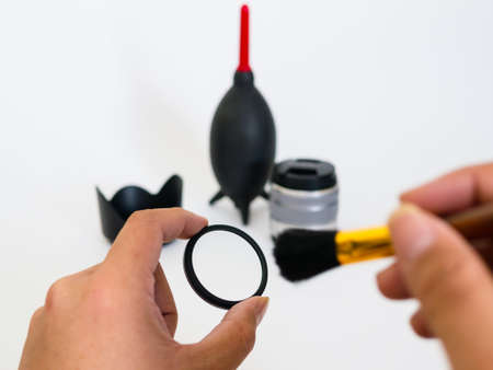 A man will be clean filter lens with brushの写真素材
