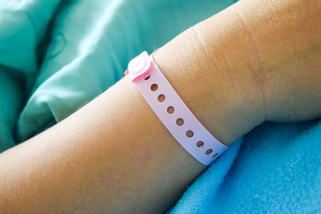 patient hand with hospital wrist tagの写真素材