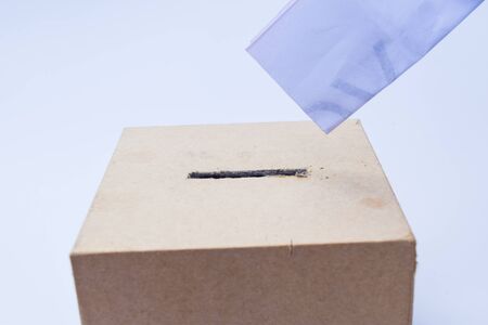 close up of a ballot box and casting vote on white backgroundの写真素材