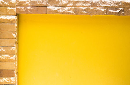 yellow background with brick stoneの写真素材