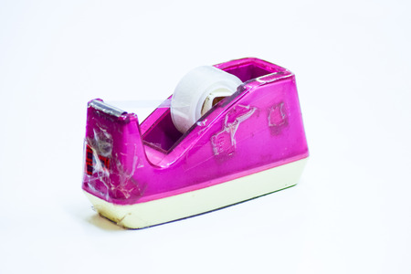 Old pink scotch tape holder isolated over white backgroundの写真素材