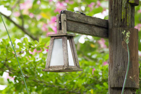 wooden lamp with green tree backgroundの写真素材