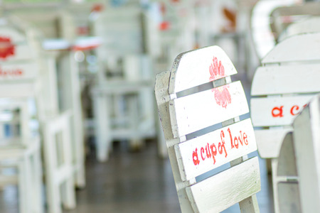 group of white chair and table  with a cup of love text in coffee shopの写真素材