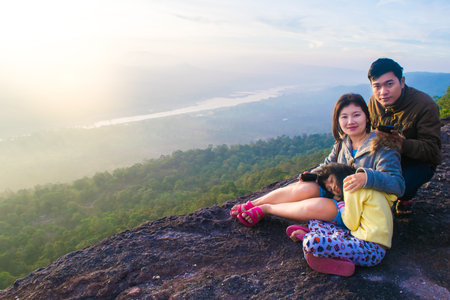 happy family on a cliff with misty and foggyの写真素材