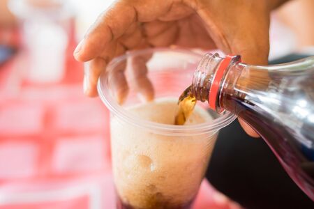 pouring soft drink colaの写真素材