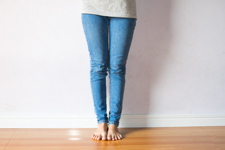 woman legs with blue jean on white backgroundの写真素材