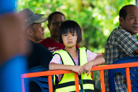 a baby girl with life jacket on a boat at sirindhorn dam in Ubon Ratchathani,THAILAND 2017のeditorial素材