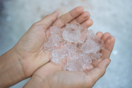 Hand holding ice cubes