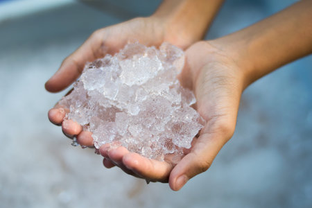 hand holding ice cubesの写真素材